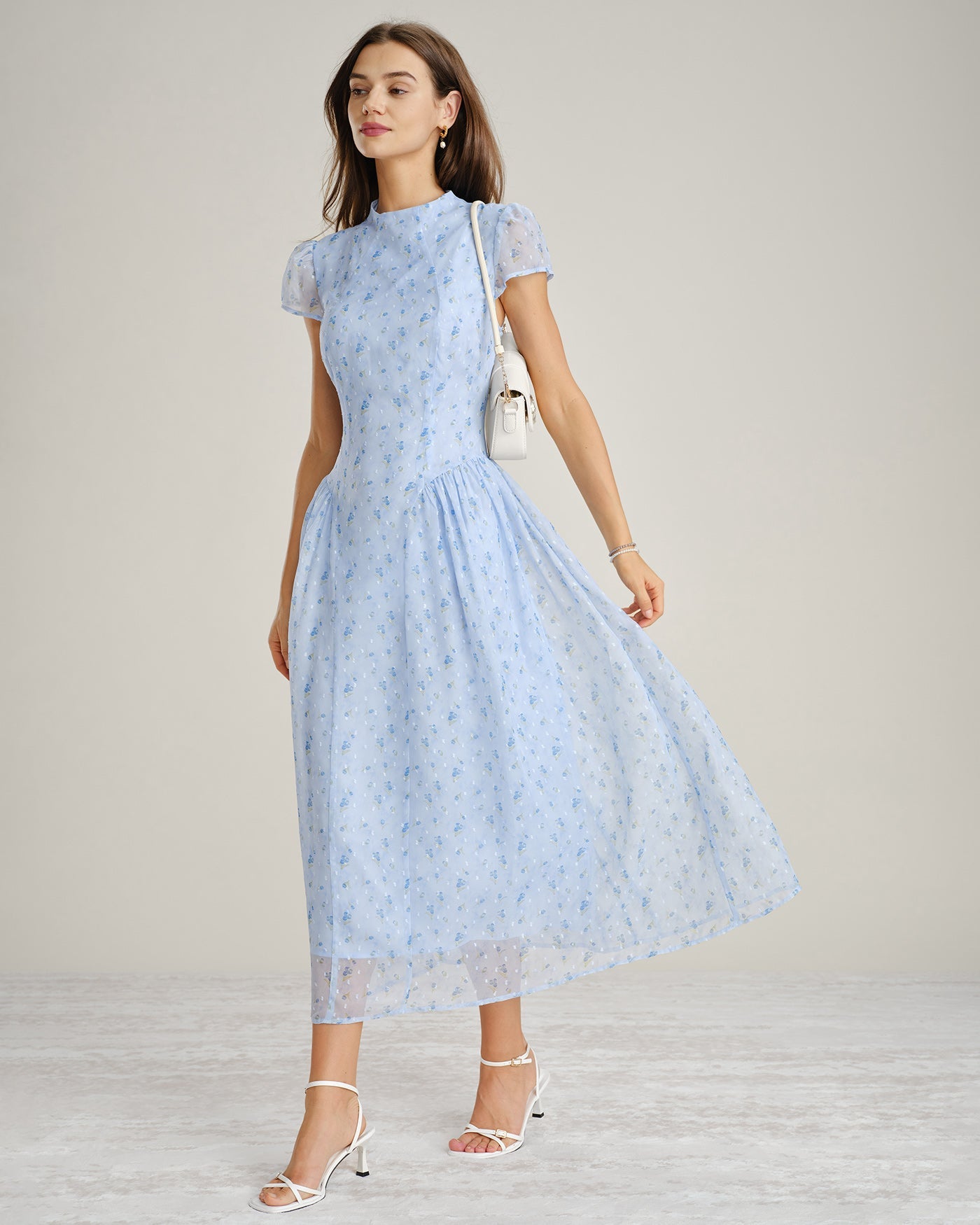 Vestido largo de gasa azul con cuello alto y cuerpo fruncido, vista lateral